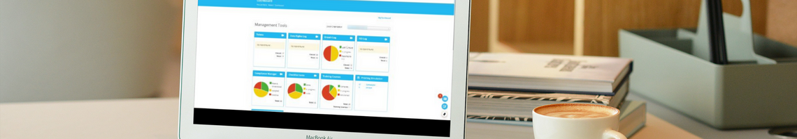 DPE Knowledge Bank dashboard on a laptop screen on a desk